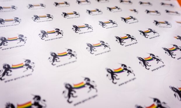 Stickers featuring the government crest and a rainbow flag