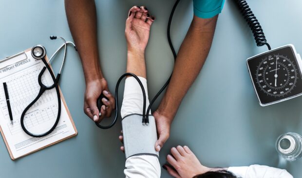 A doctor taking a patients blood pressure