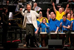 David Stanley and chorus on stage